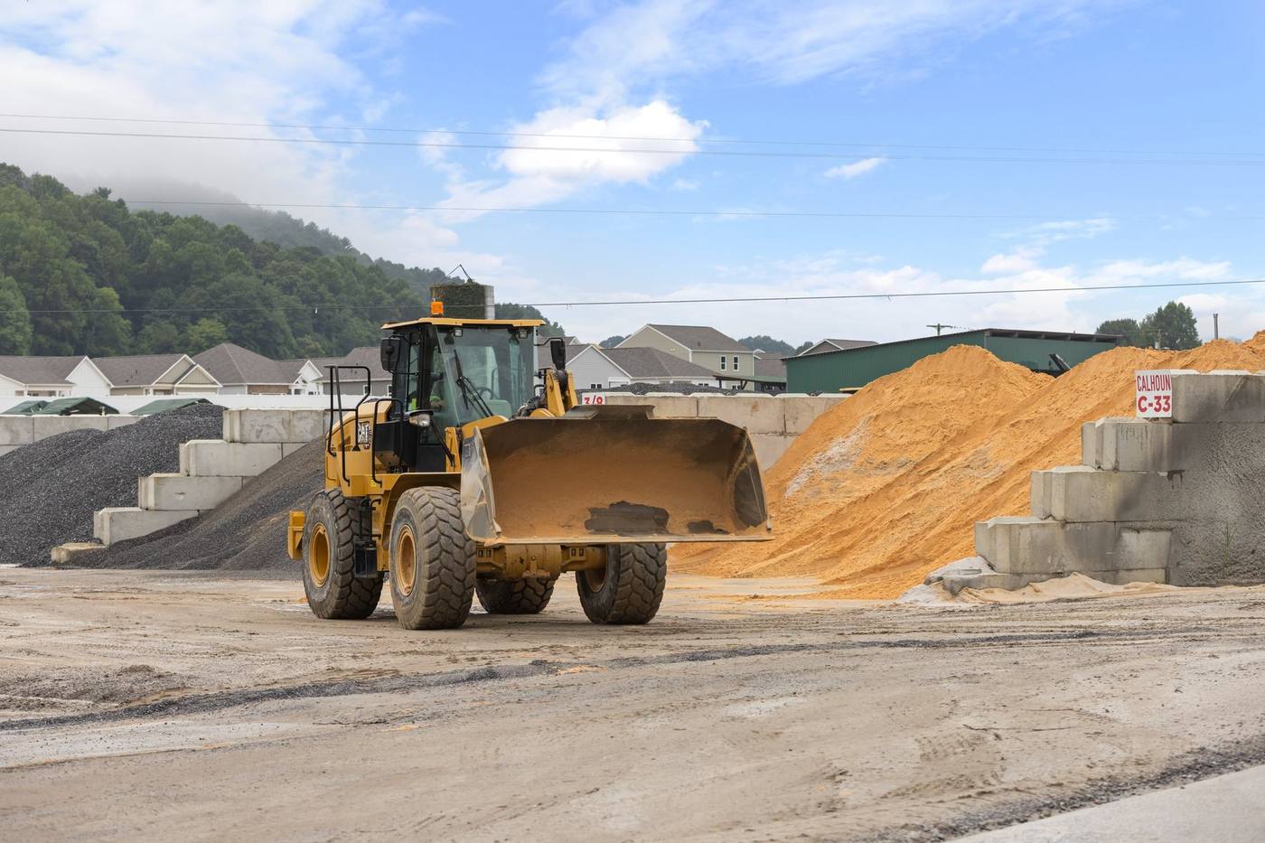 CAT wheel loader working the sand and stone bays at THE YARD