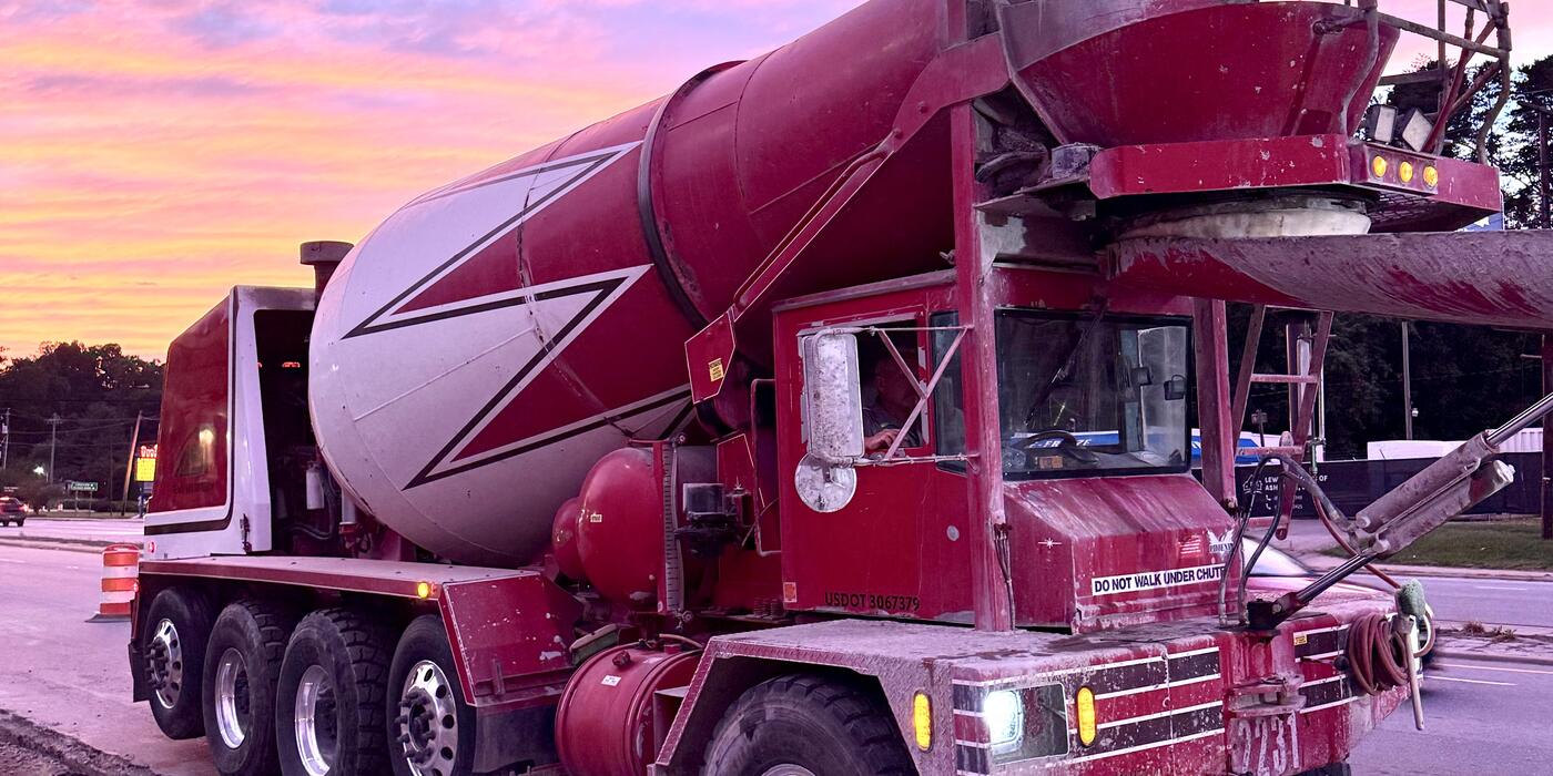 ASI front-discharge mixer rolling to a pour at sunset