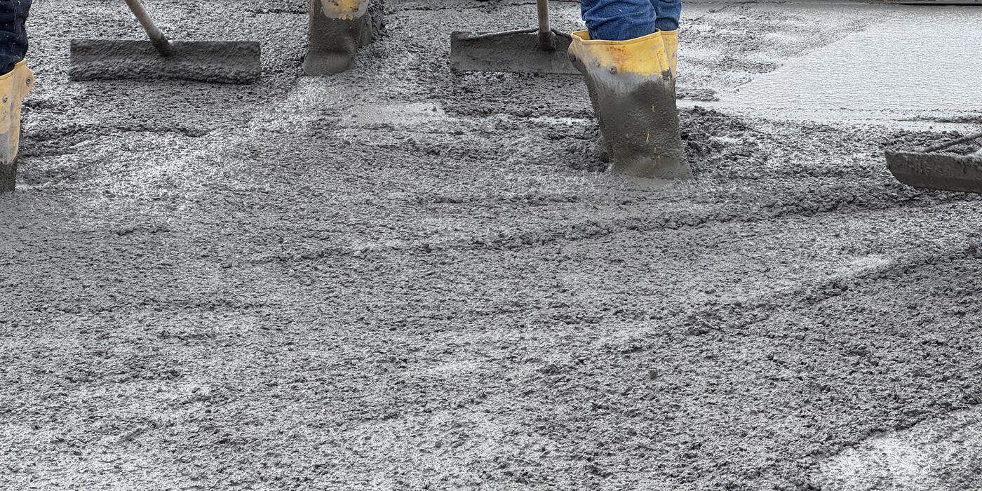 Flatwork crew screeding and floating a fresh slab